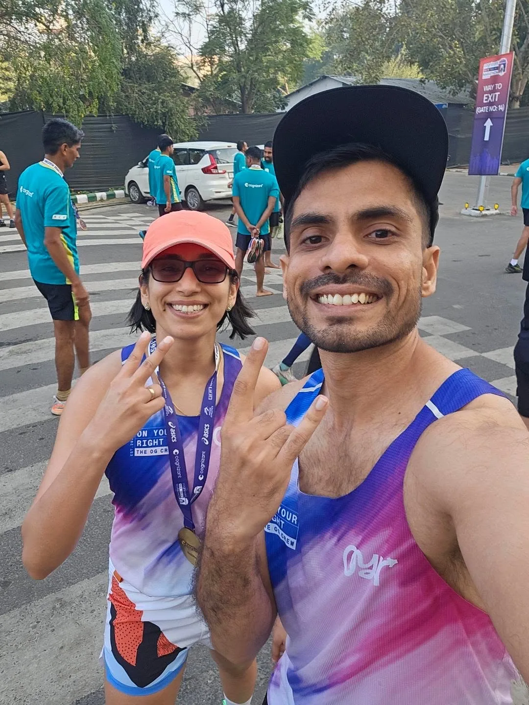 Two runners celebrating at the finish line in OYR singlets.